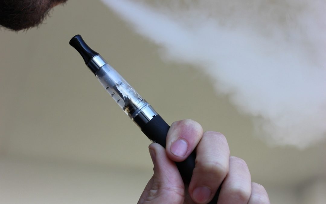 an individual vaping with smoke coming out